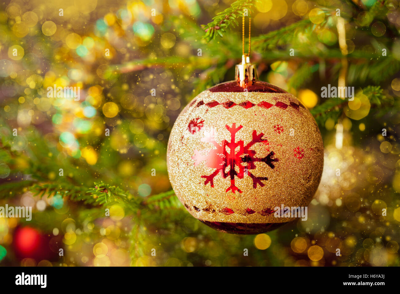 Decoration bauble on decorated Christmas tree background Stock Photo