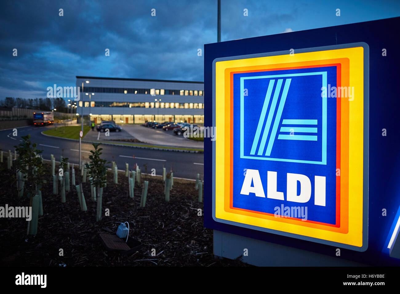 Aldi distribution center Bolton   products warehouse offices night dusk dawn sign light glowing dark Over Hulton Logistics North Stock Photo