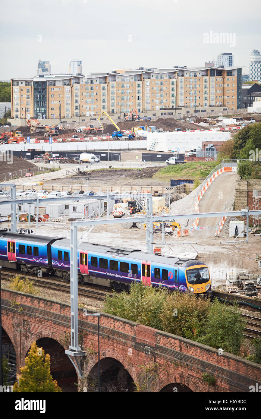 Trans pennine express railway unit   Local train passing Middlewood Locks development site complex Chinese money investment work Stock Photo