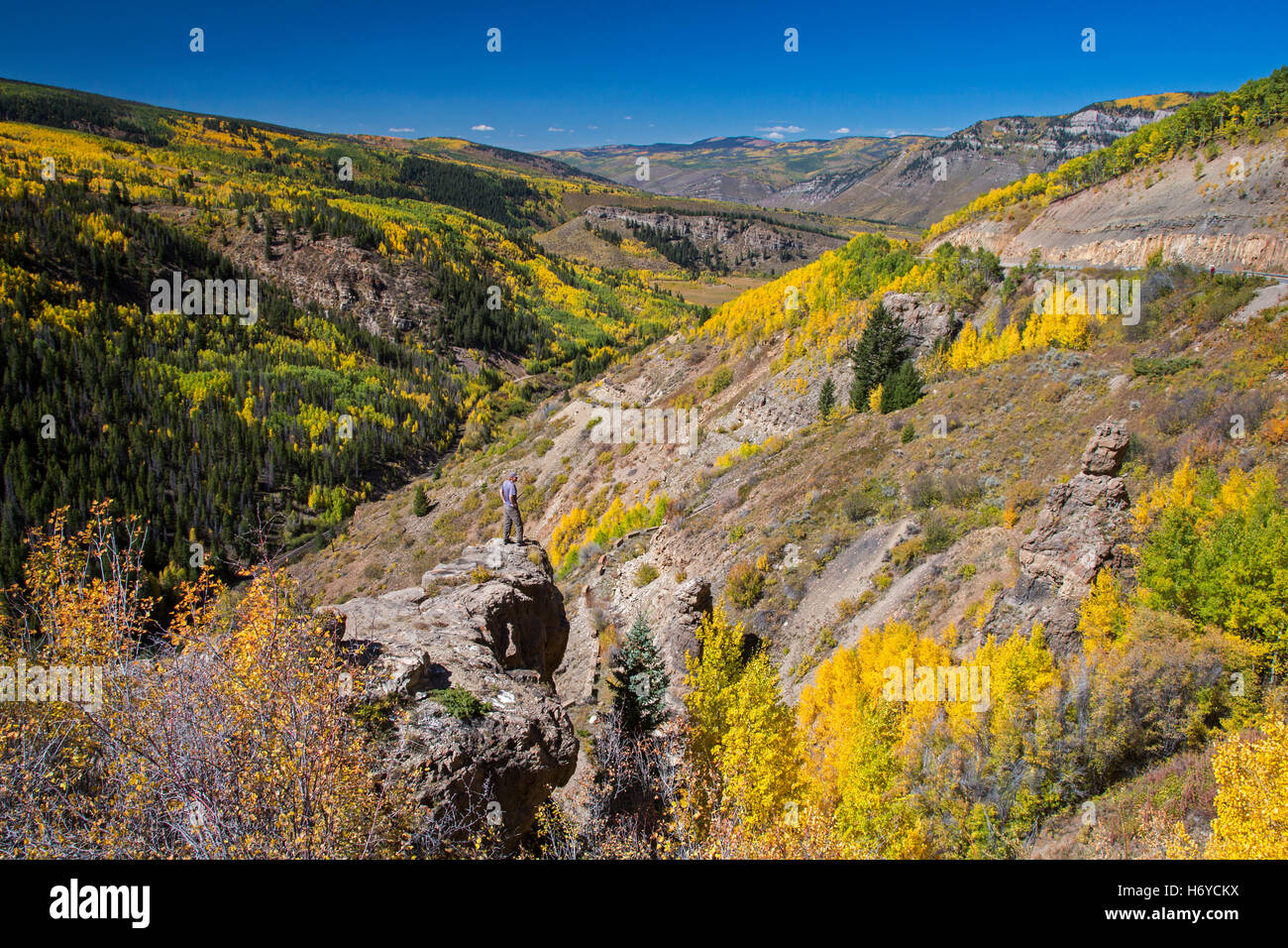 Leadville, Colorado - Autumn in the Rocky Mountains. A man stands on a rock overlooking a valley below Leadville. Stock Photo