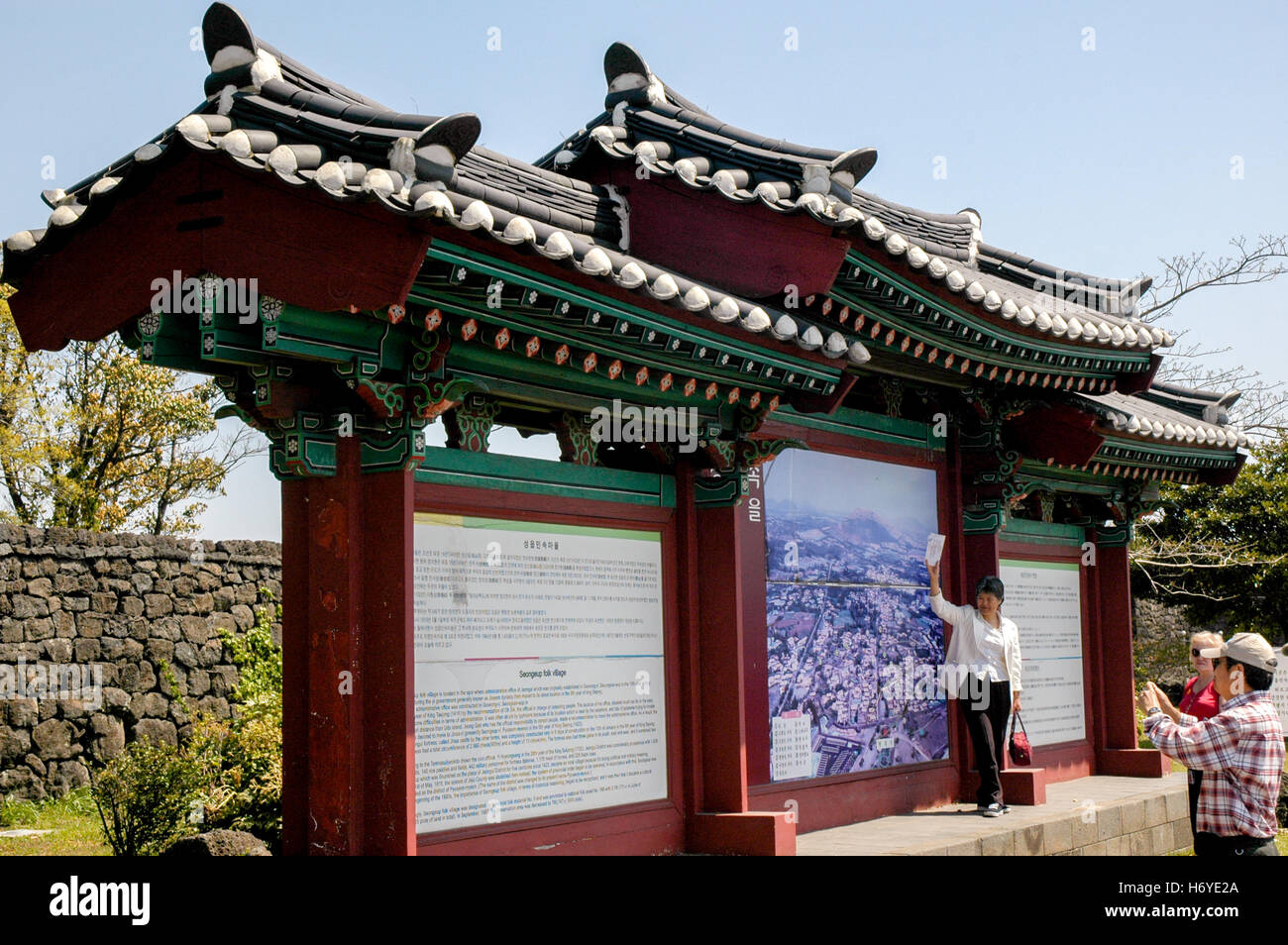 tour guide and visitors at entrance of seongeup folk village. jeju (cheju). sth korea Stock Photo