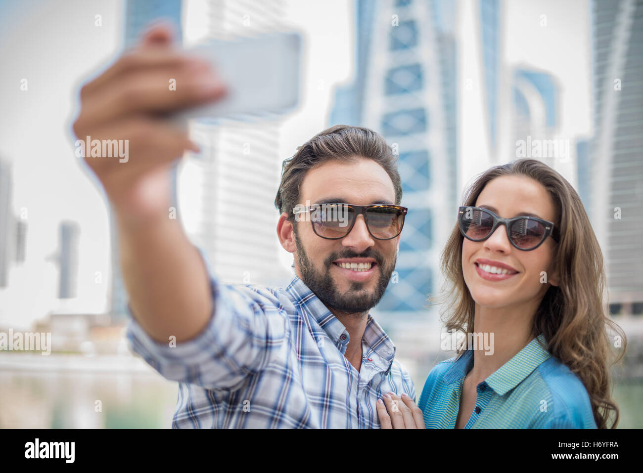 Tourist couple taking smartphone selfie, Dubai, United Arab Emirates Stock Photo