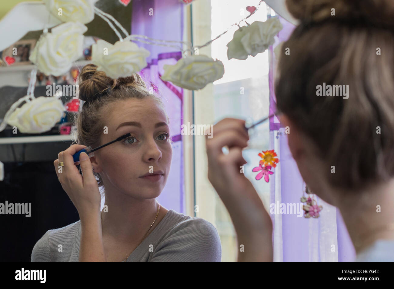 doing makeup in mirror Stock Photo