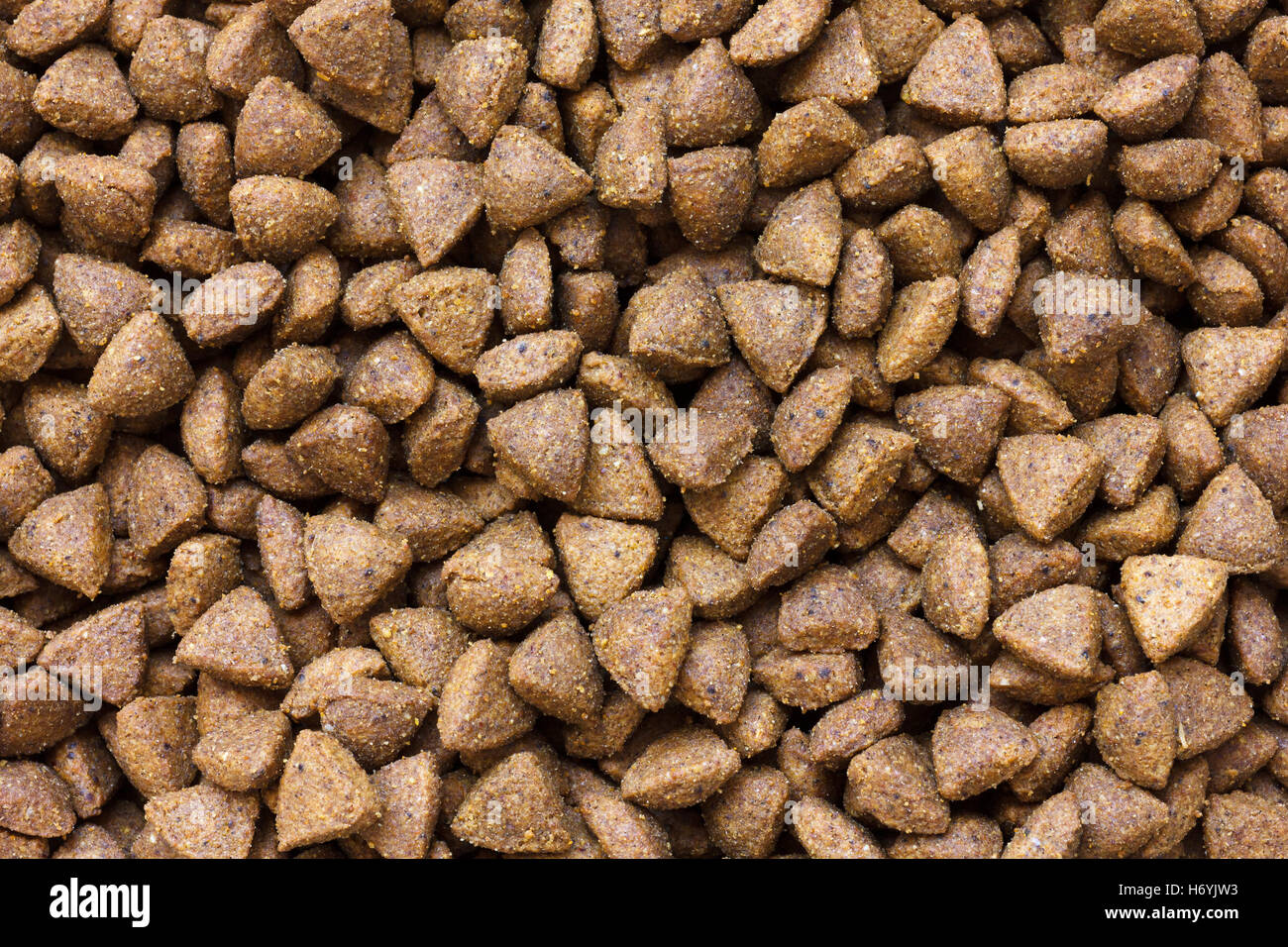 Detail of dry brown pet food. From above. Stock Photo