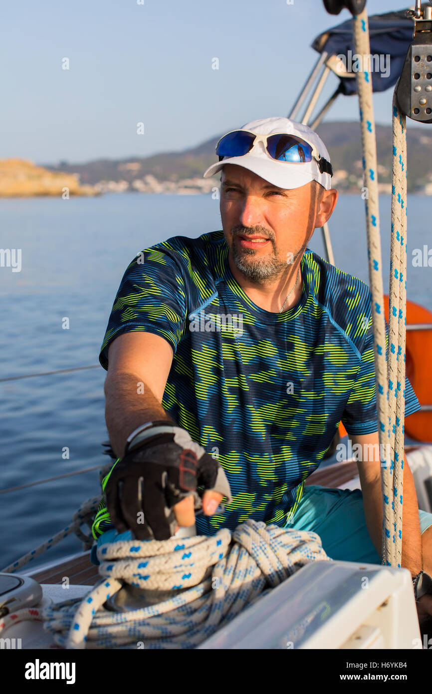 Male skipper on his yacht sailing boat Stock Photo Alamy