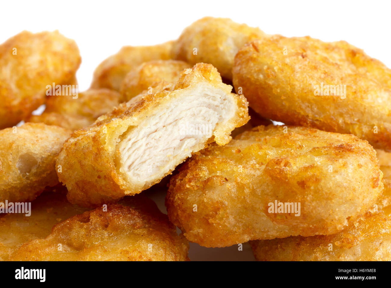 Detail of golden deepfried battered chicken nuggets with white