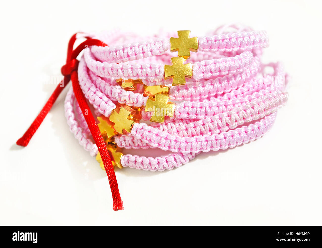 pink macrame bracelets with gold cross - Orthodox christening bracelets Stock Photo
