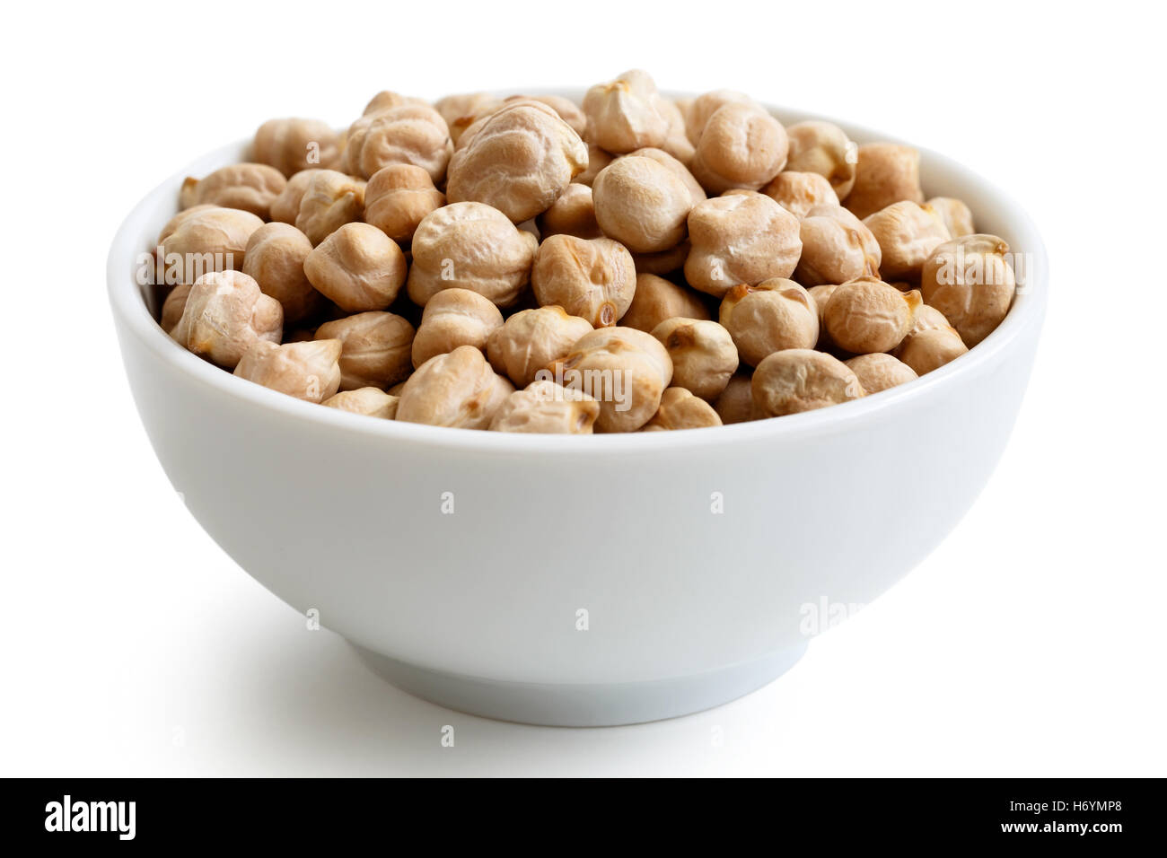 Dried chickpeas in white bowl isolated on white. Stock Photo