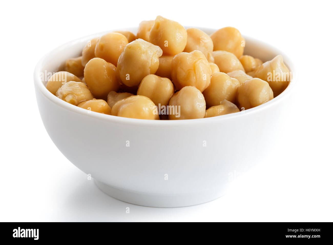 Cooked chickpeas in white bowl isolated on white. Stock Photo