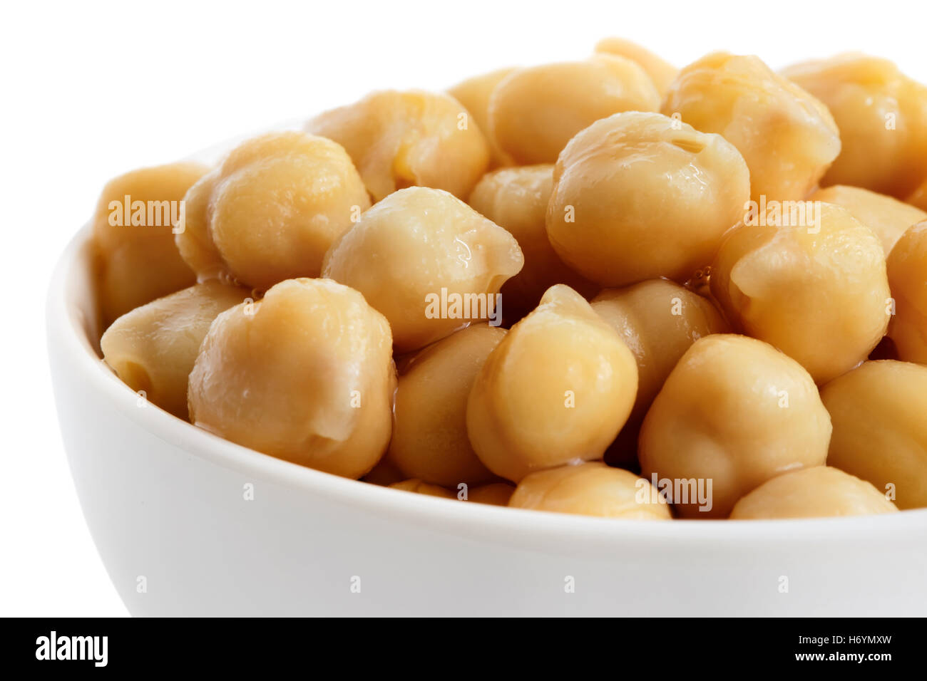 Detail of cooked chickpeas in white bowl on white. Stock Photo