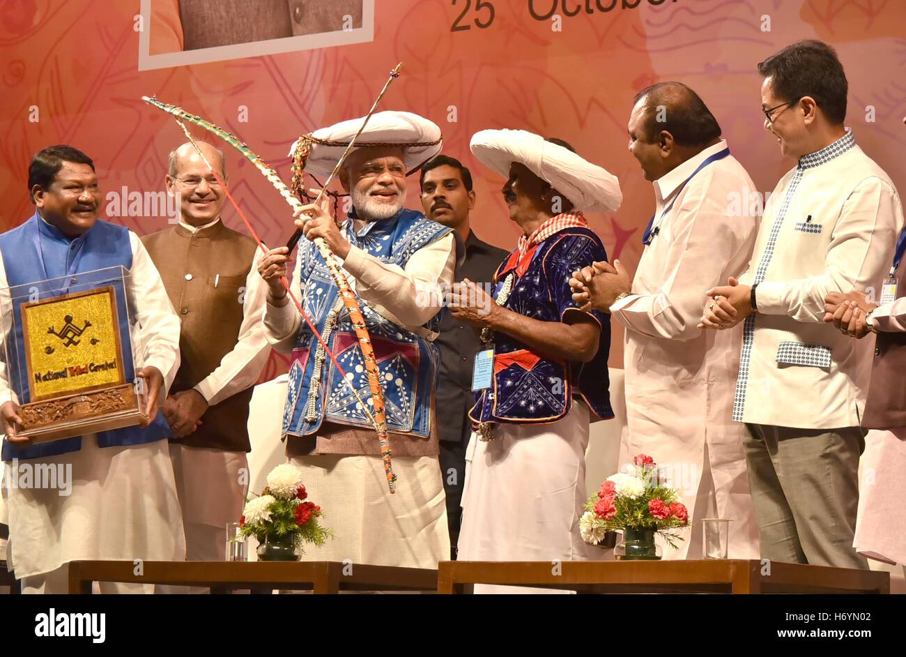 Indian Prime Minister Narendra Modi wearing a tribal hat inaugurates the National Tribal Carnival October 25, 2016 in New Delhi, India. Standing with the Prime Minister is Union Minister for Tribal Affairs, Jual Oram, the Minister of State for Environment, Forest and Climate Change Anil Madhav Dave and the Minister of State for Home Affairs, Kiren Rijiju. Stock Photo