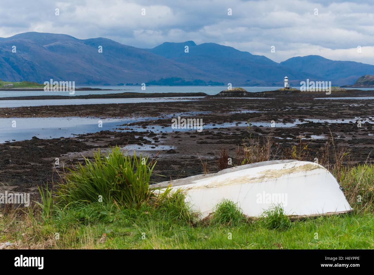 View from port appin over to Creach Bheinn with lighthouse and boat in foreground Stock Photo