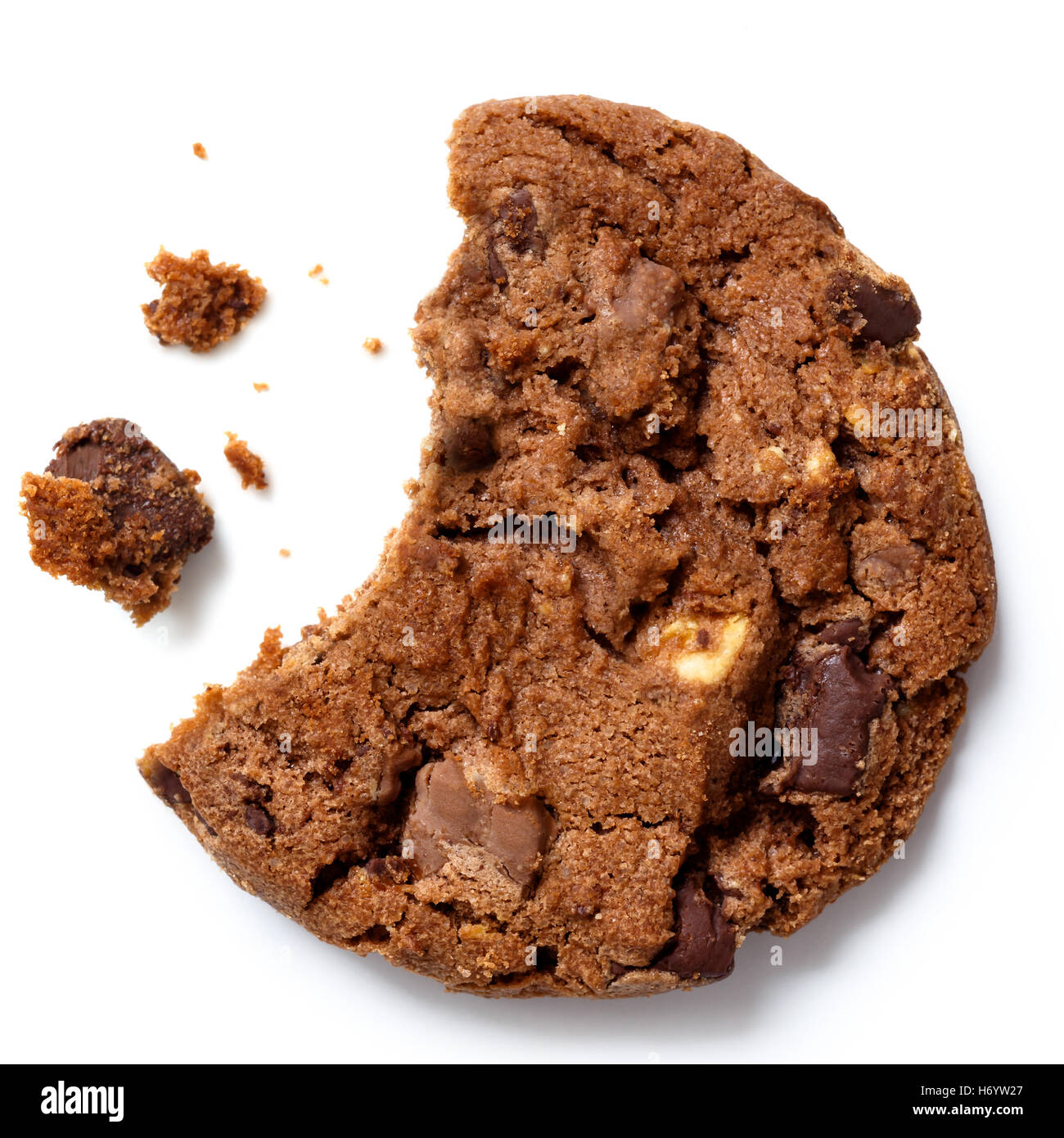 Chocolate chip cookie, bite missing with crumbs from above. Stock Photo