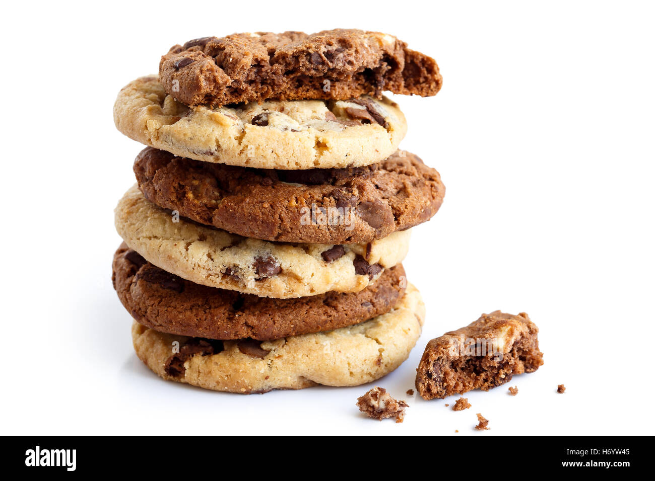 Stack of light and dark chocolate chip cookies isolated. One half with crumbs. Stock Photo