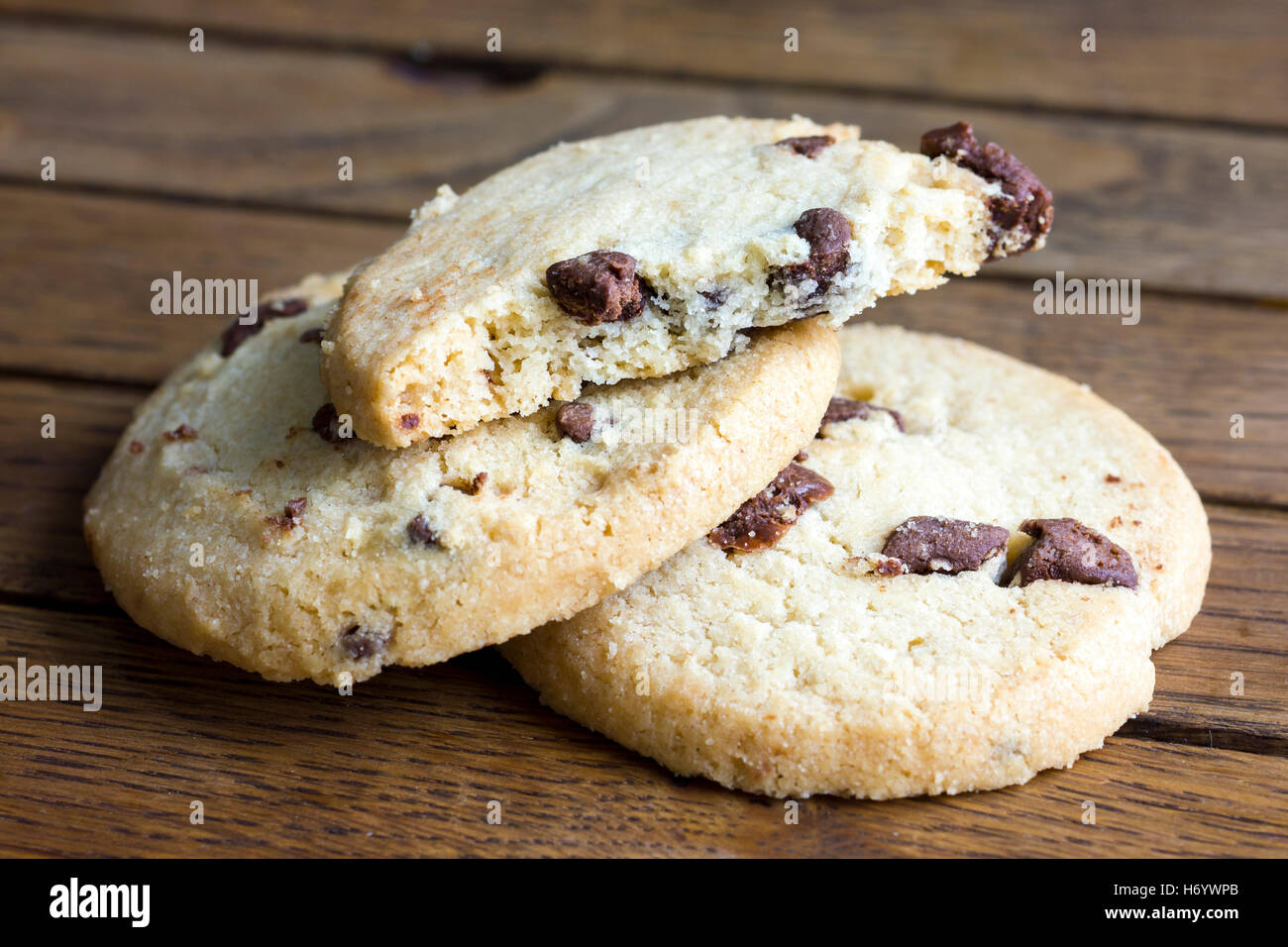 Round chocolate chip shortbread biscuits. On rustic wood Stock Photo