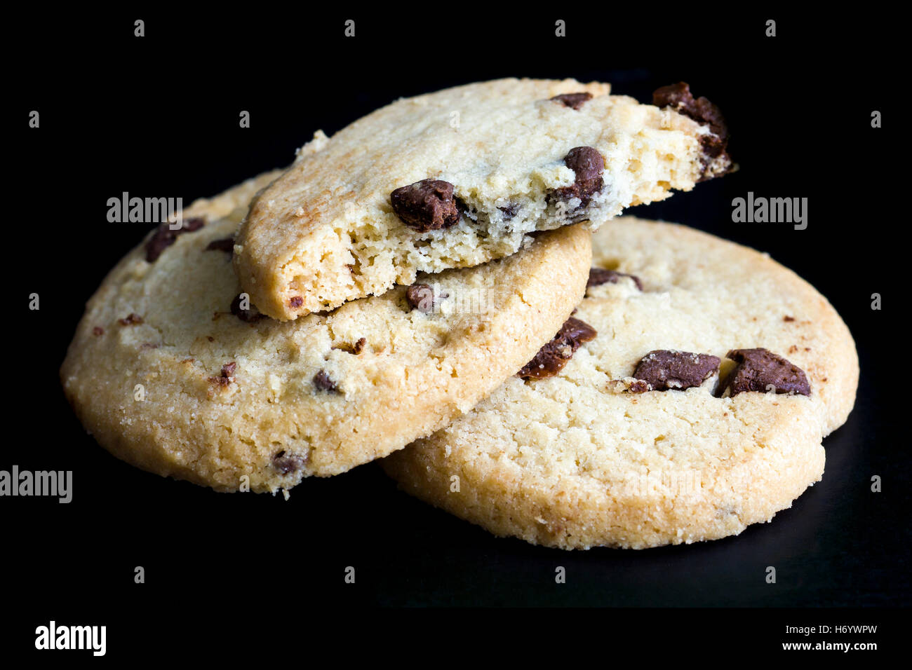 Round chocolate chip shortbread biscuits. On black. Stock Photo