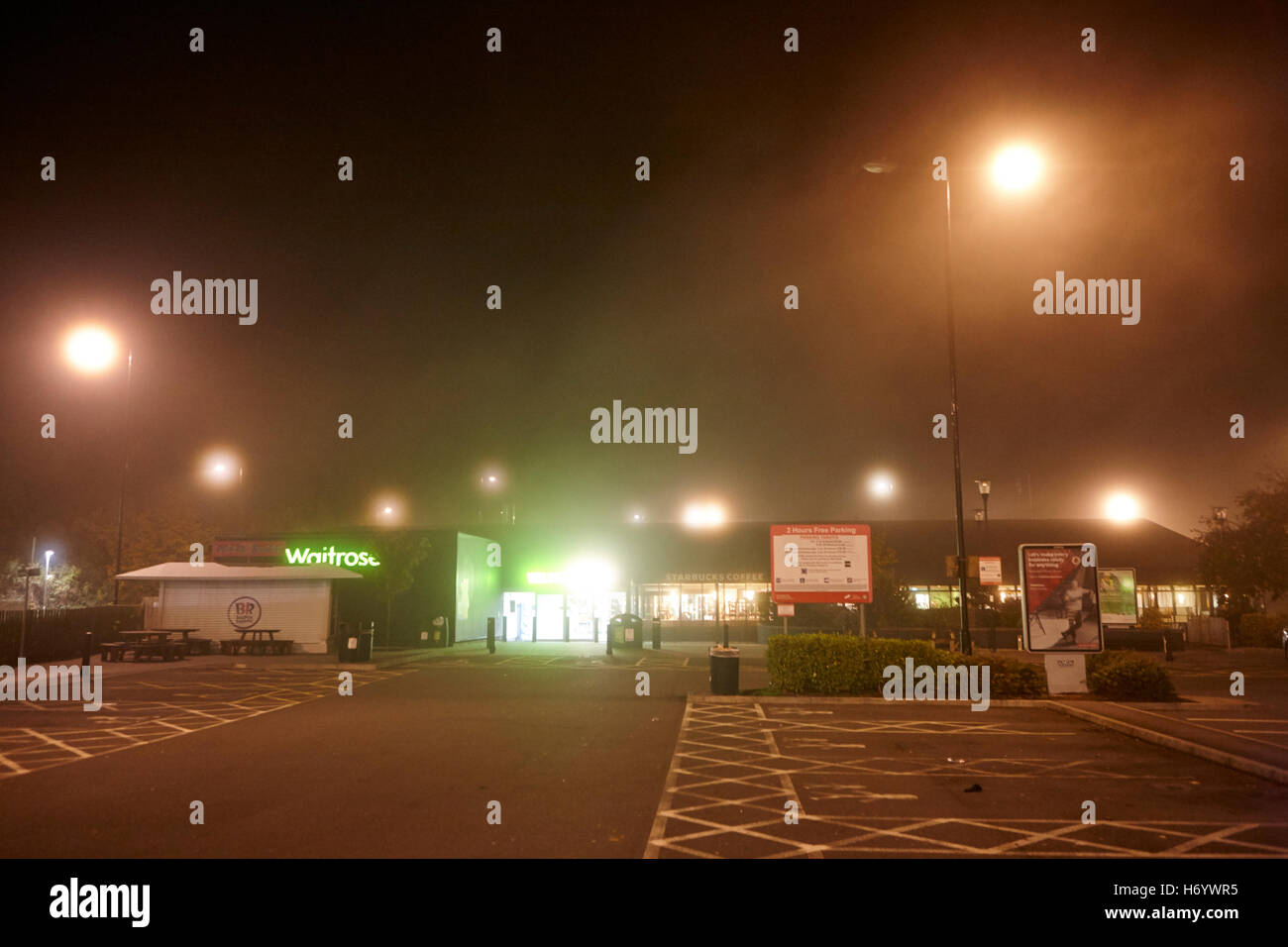 empty welcome break motorway service station at night in fog United Kingdom Stock Photo