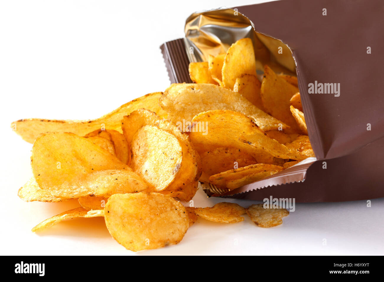 Open packet of crisps on white Stock Photo