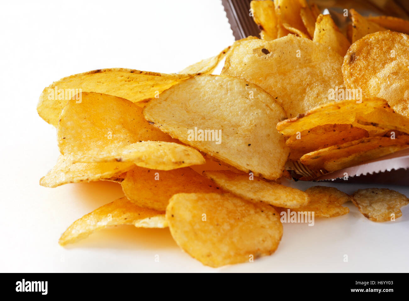 Open packet of crisps on white Stock Photo