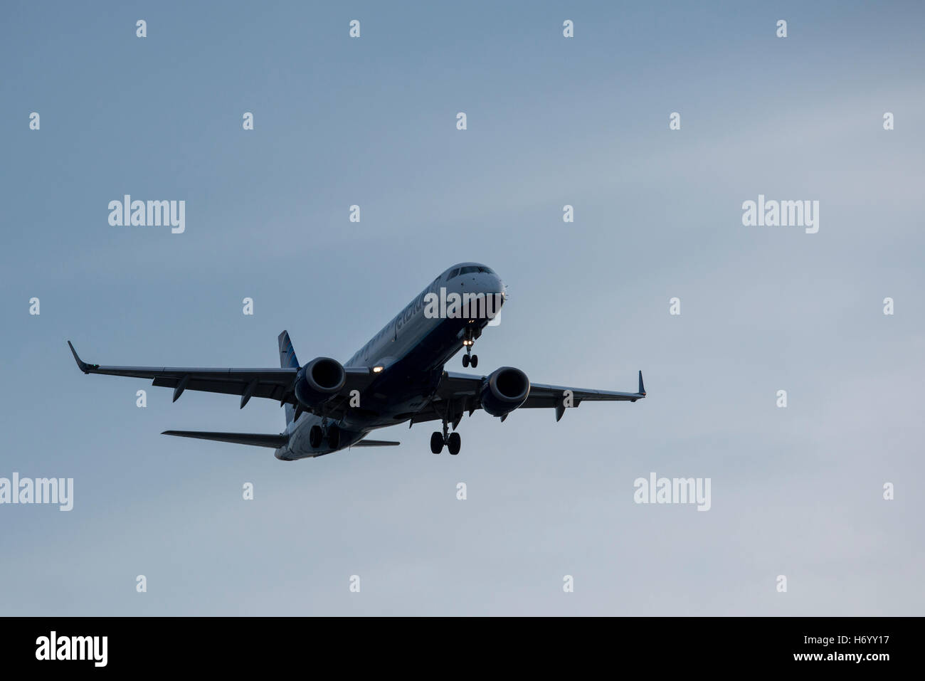 Massachusetts, Boston. Jet Blue airplane flying into Boston Logan airport. Stock Photo