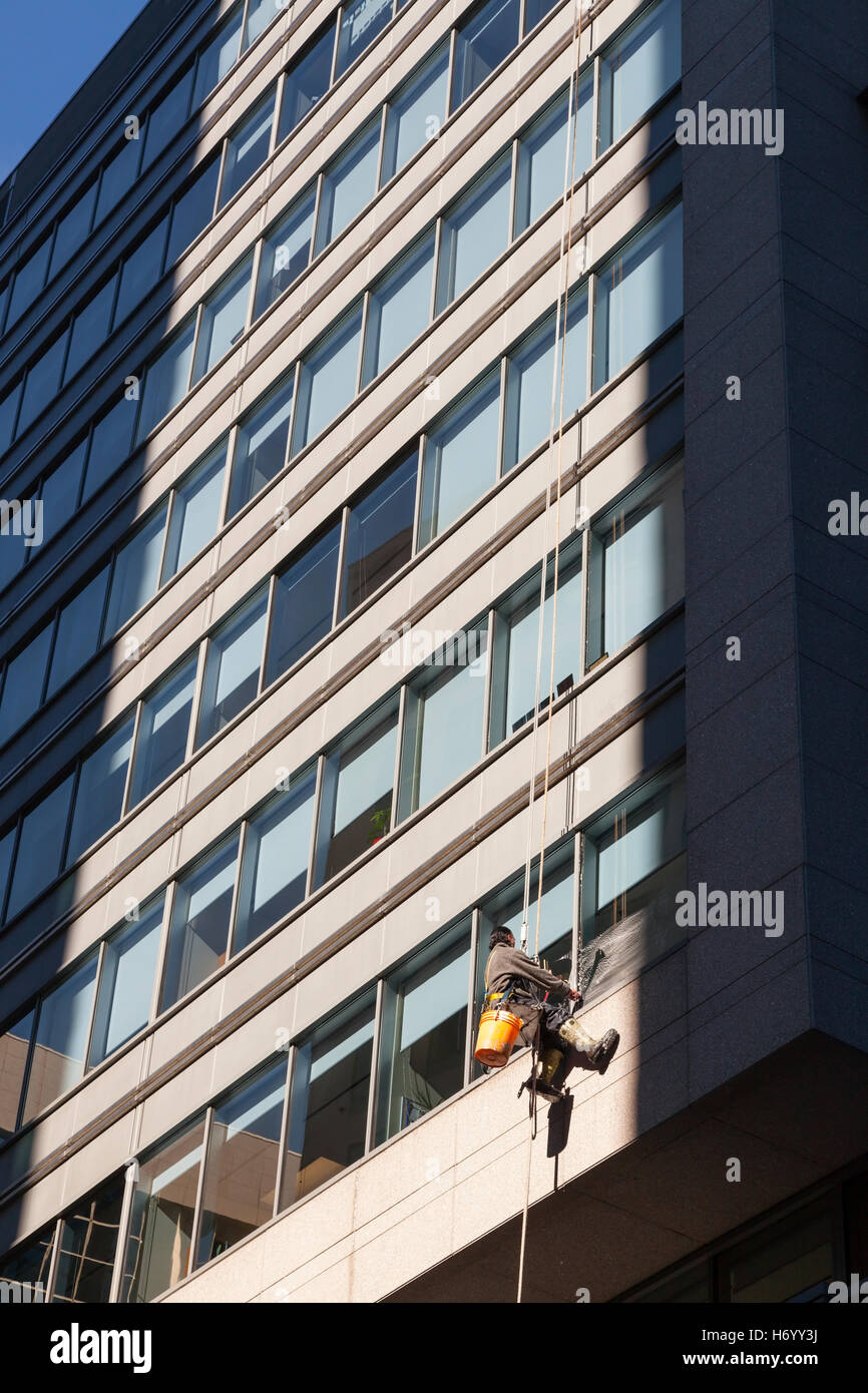 A worker washing windows on a building in Ottawa, Ontario, Canada. Stock Photo