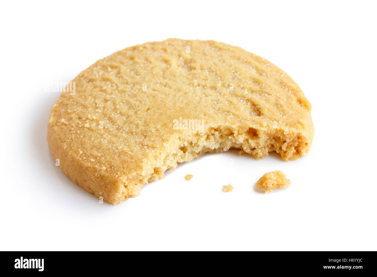 Single round shortbread biscuit with crumbs and bite missing. In perspective. Stock Photo