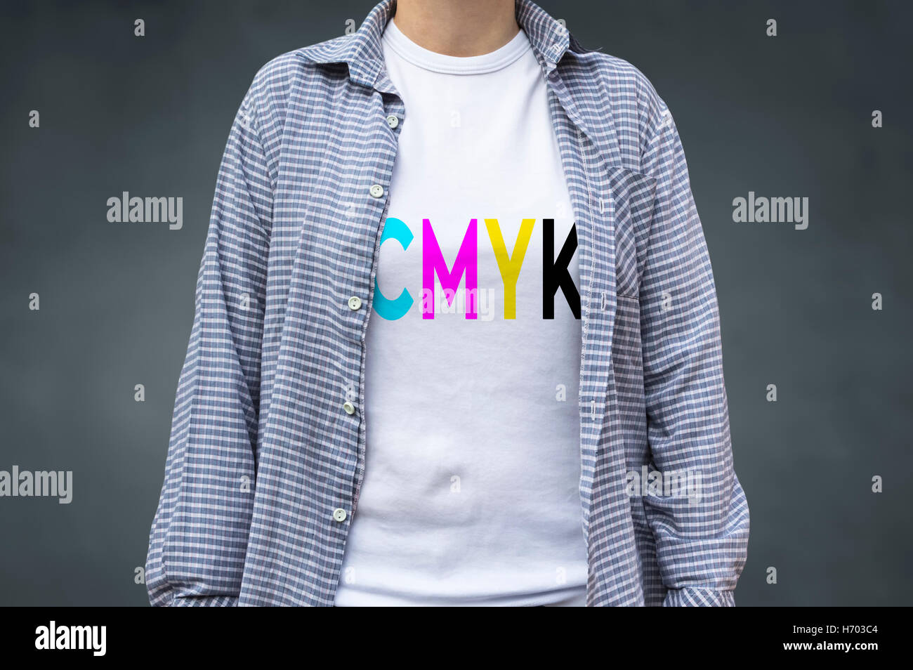CMYK digital printing on T-shirt, cyan, magenta, yellow and black letters. Selective focus. Stock Photo