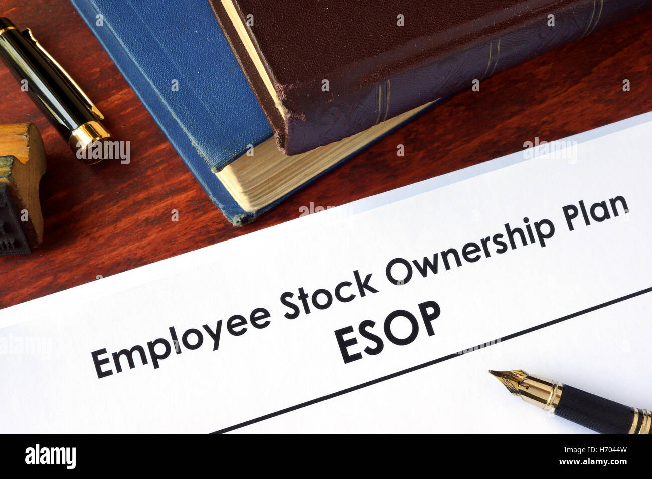 Papers with Employee Stock Ownership Plan (ESOP) on a table. Stock Photo