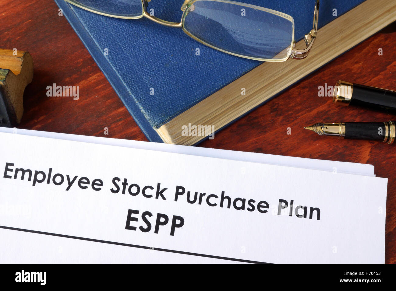Papers with ESPP Employee Stock Purchase Plan on a table. Stock Photo