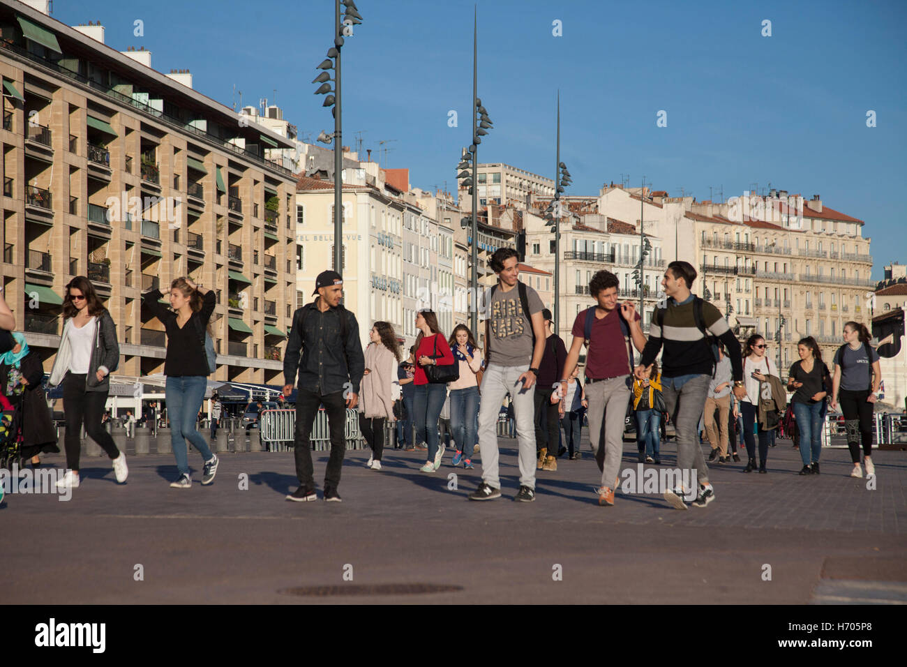 Young people walking beside Vieux Port, Marseille, France Stock Photo