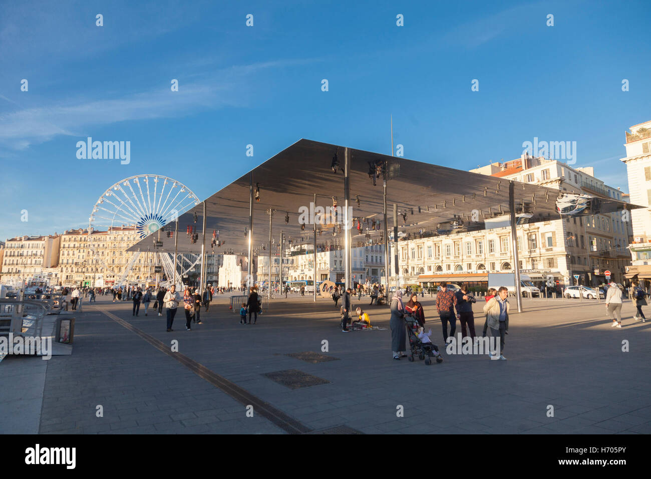 People under Norman Fosters giant pavilion mirror on the waterfront promenade in the Old Port of Marseille (Vieux-Port) Stock Photo
