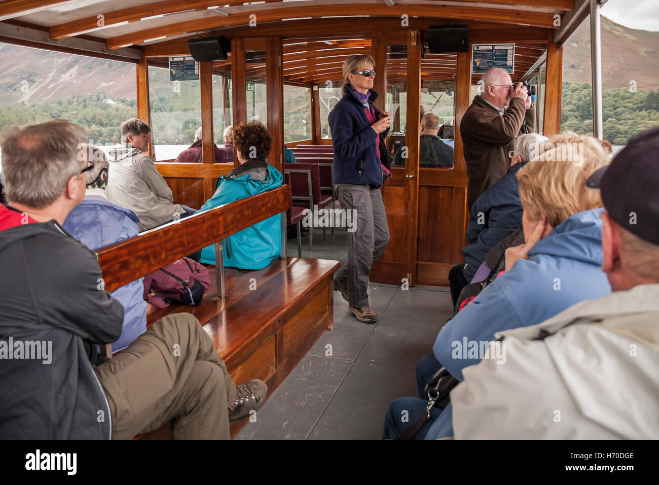 Tourists enjoying a boat tour round Derwentwater in the Lake District National Park,Cumbria,England Stock Photo