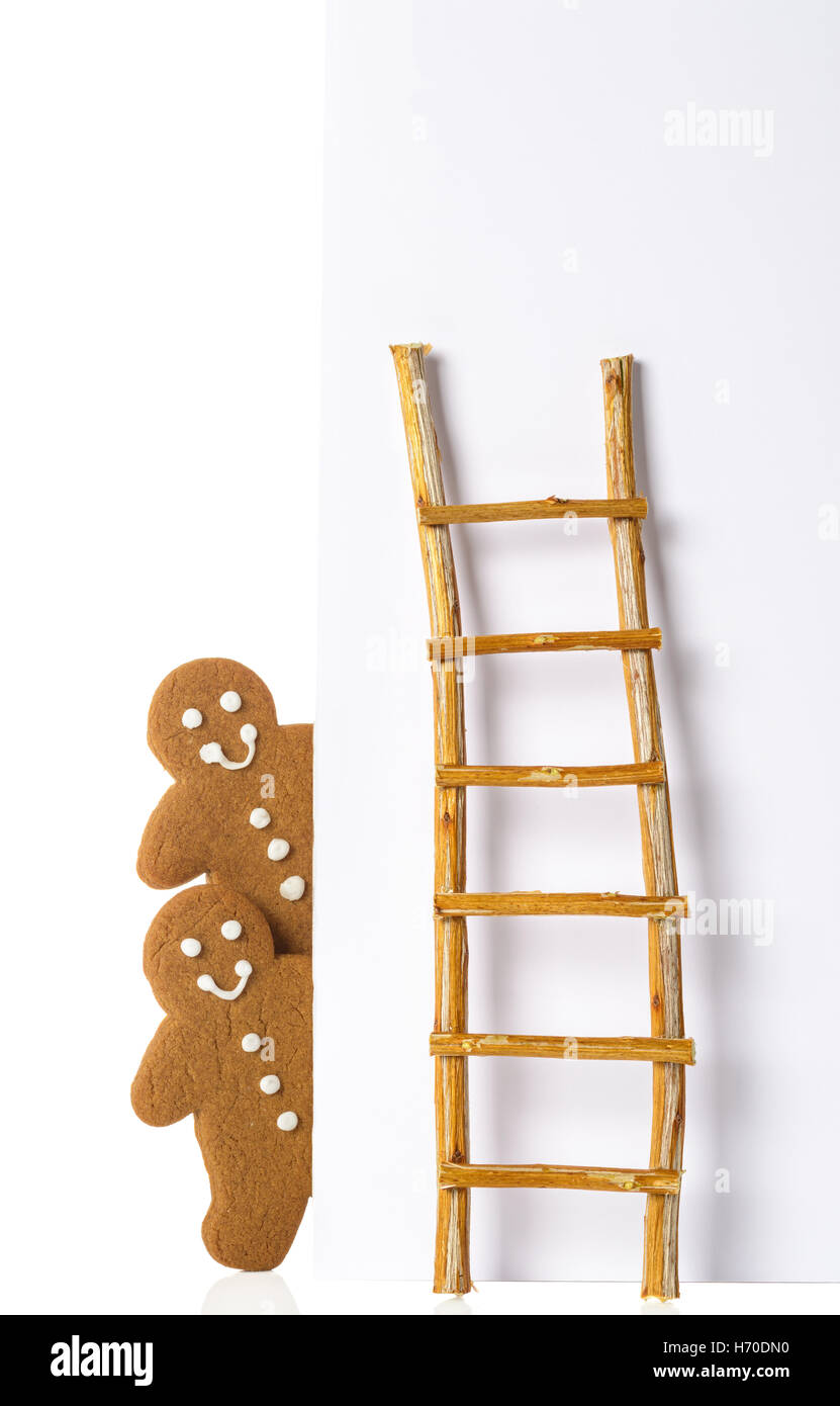 Gingerbread men against advertising board with ladder Stock Photo