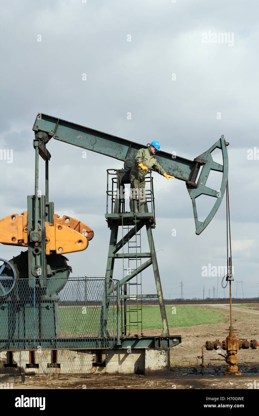oilfield with worker and pump jack Stock Photo Alamy