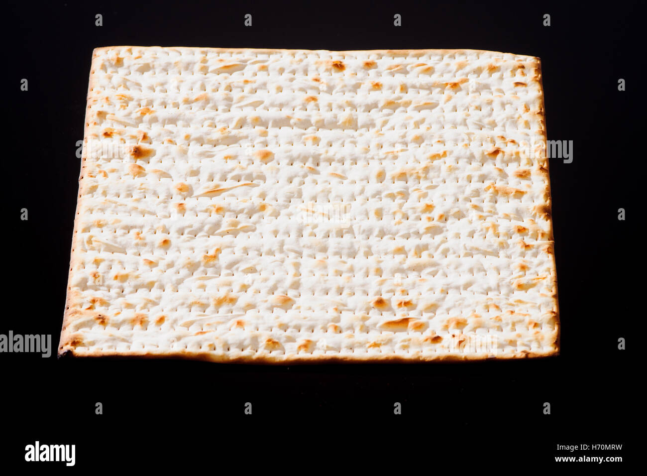 Matzo - A traditional Jewish Passover bread on a black background Stock Photo