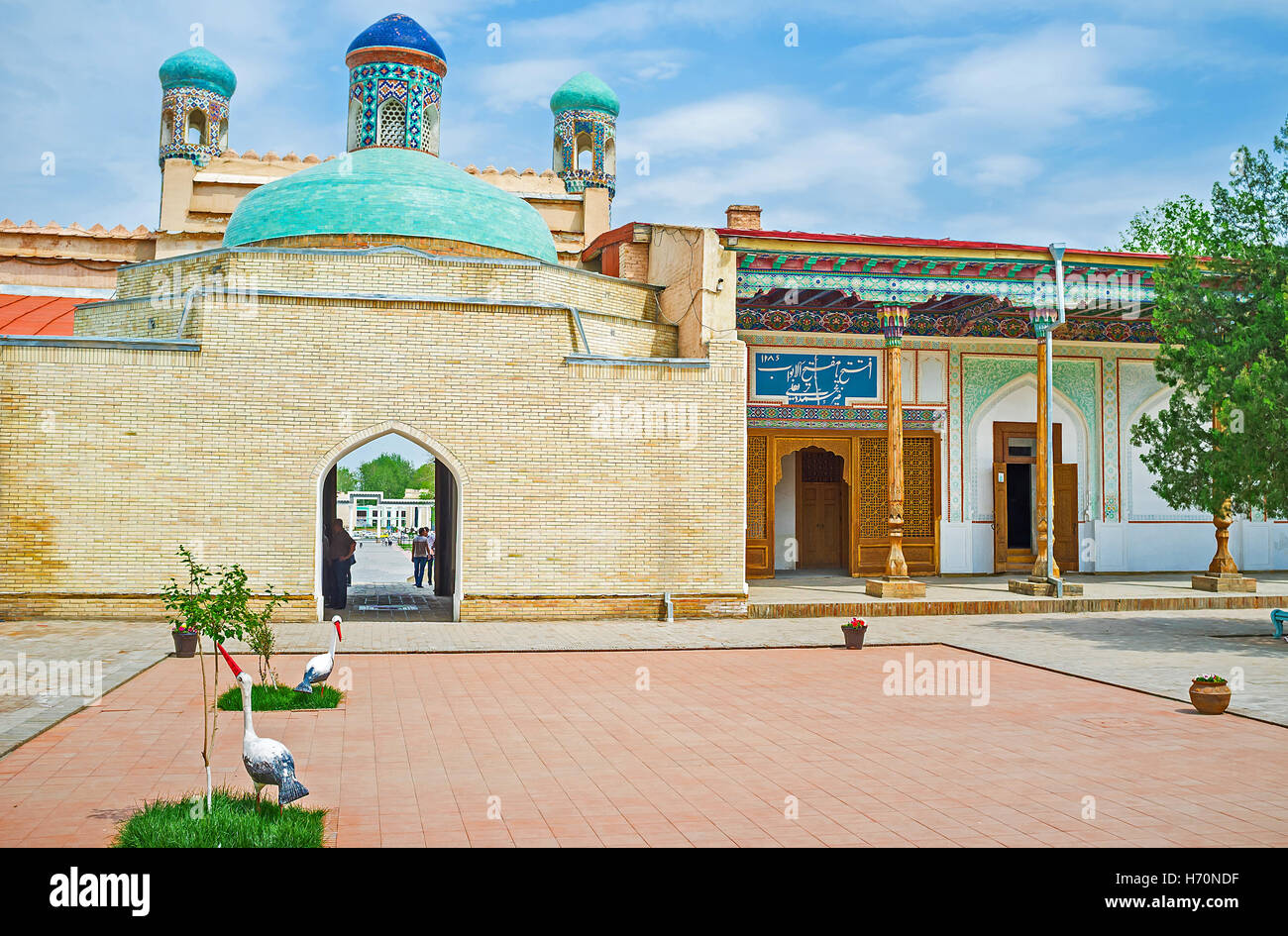 The main gate of Khudayar Khan Palace is topped with the bright green dome, covered with the glazed tiles Stock Photo