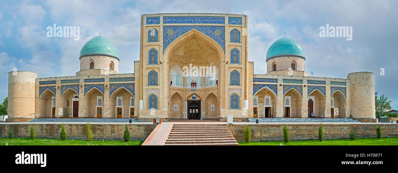 The facade of the Norbut-biy Madrasah, with the huge portal, decorated with arabesques and two domes Stock Photo