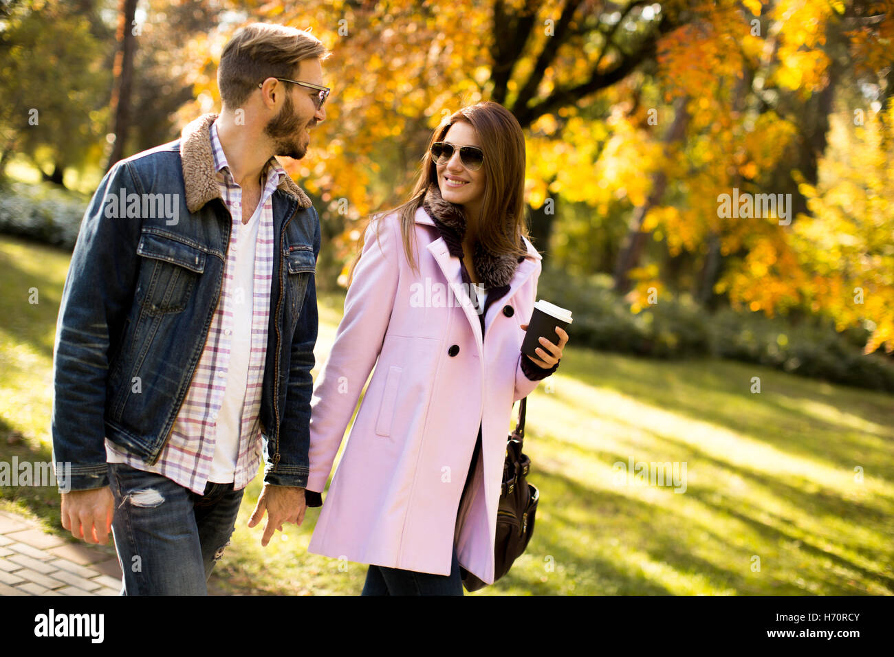 Young loving couple having a walk in the autumn park Stock Photo - Alamy