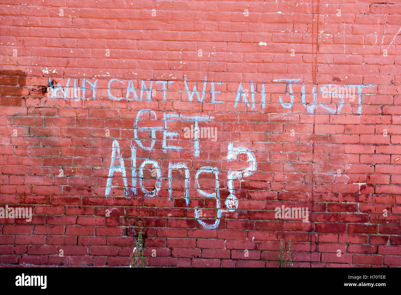 Why Can't We All Get Along written on a wall in an alley in Brattleboro, VT. Stock Photo
