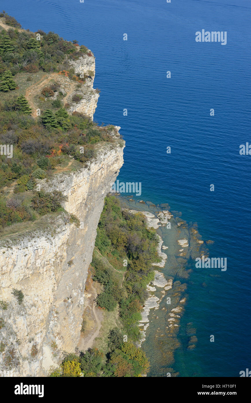 AERIAL VIEW. Vertiginous cliff overhanging high above Lake Garda. Rocca di Manerba, Manerba del Garda, Province of Brescia, Lombardy, Italy. Stock Photo