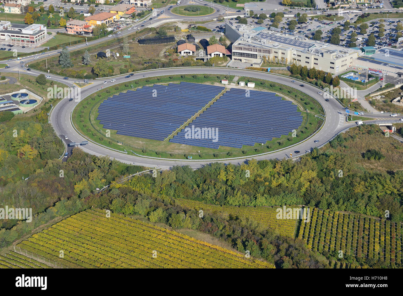 AERIAL VIEW. Photovoltaic panels installed inside a traffic circle. Affi, Province of Verona, Veneto, Italy. Stock Photo
