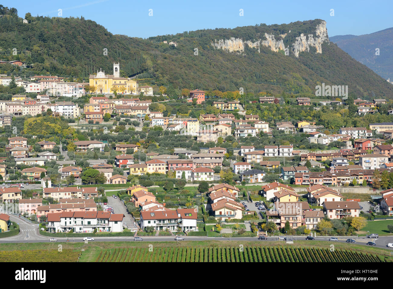 AERIAL VIEW. Hilltop town with a background of forest and cliff. Cavaion Veronese, Province of Verona, Veneto, Italy. Stock Photo