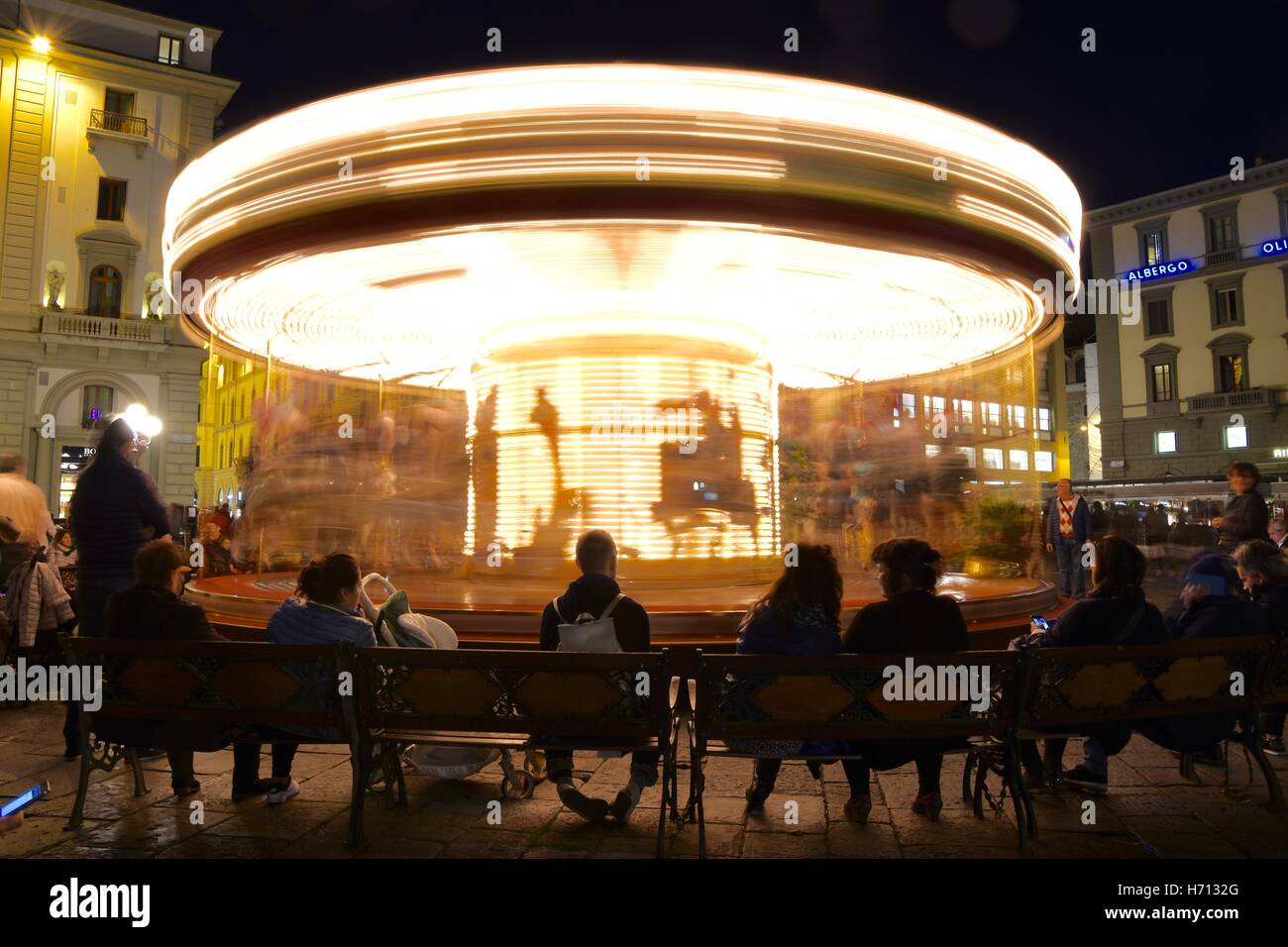 Merry-go-round photographed in the evening, with a slow shutter speed, on the Piazza della Republica, Florence, Tuscany, Italy. Stock Photo