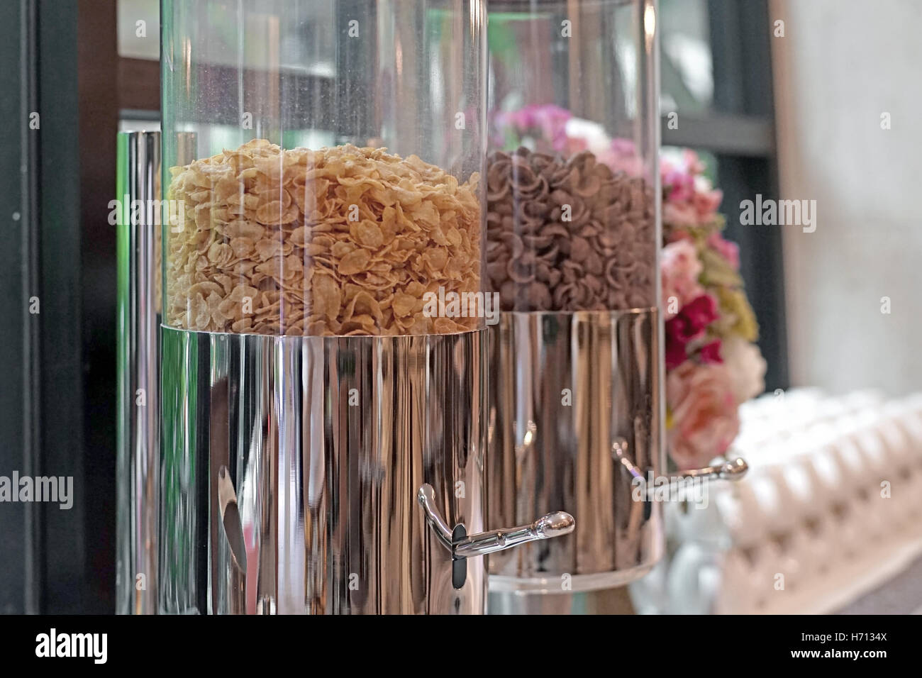 different kind of cereal cornflakes in a glass jar on buffet table Stock Photo