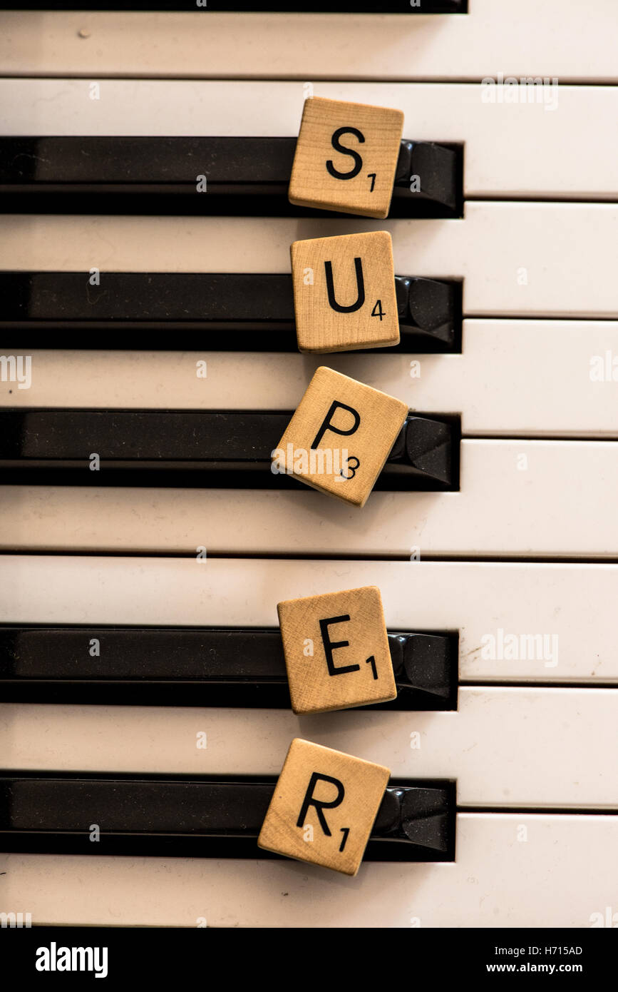 the word super written with wooden letters at piano Stock Photo
