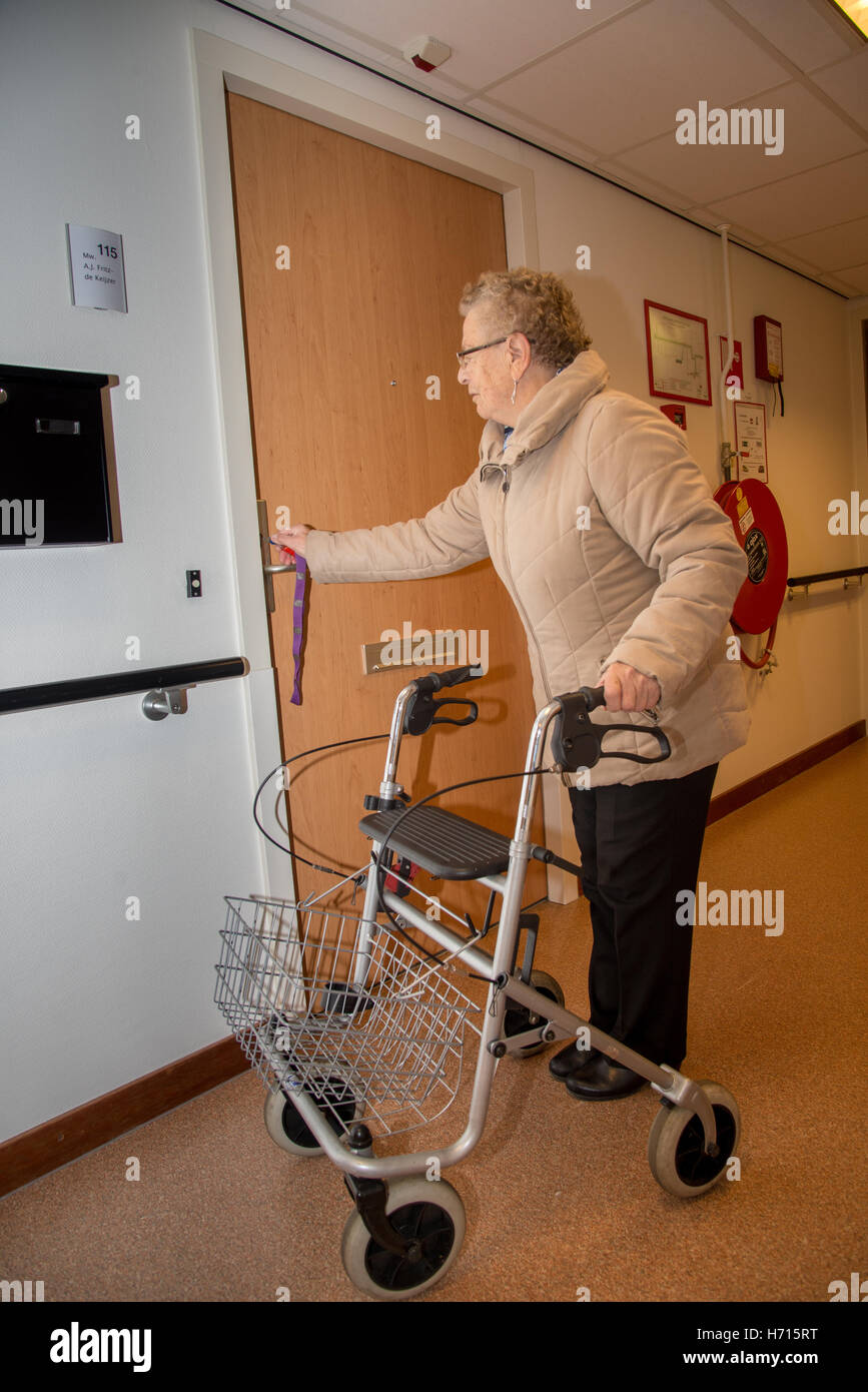 old woman with assist for walking at house Stock Photo