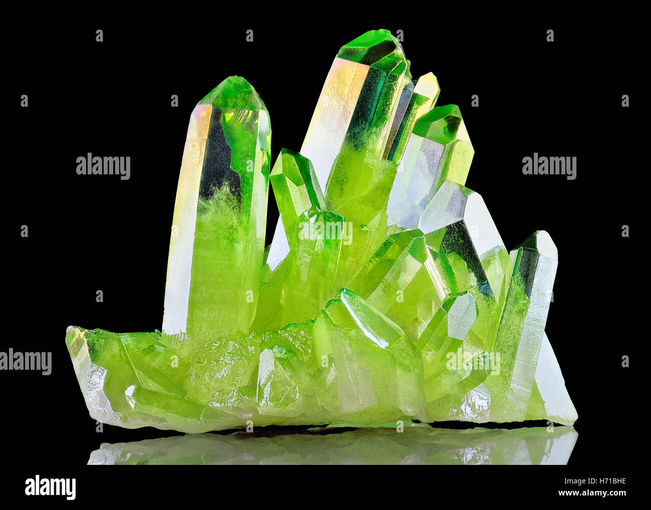 Rare shiny Green Quartz Titanium Aura Crystal cluster on black background Stock Photo