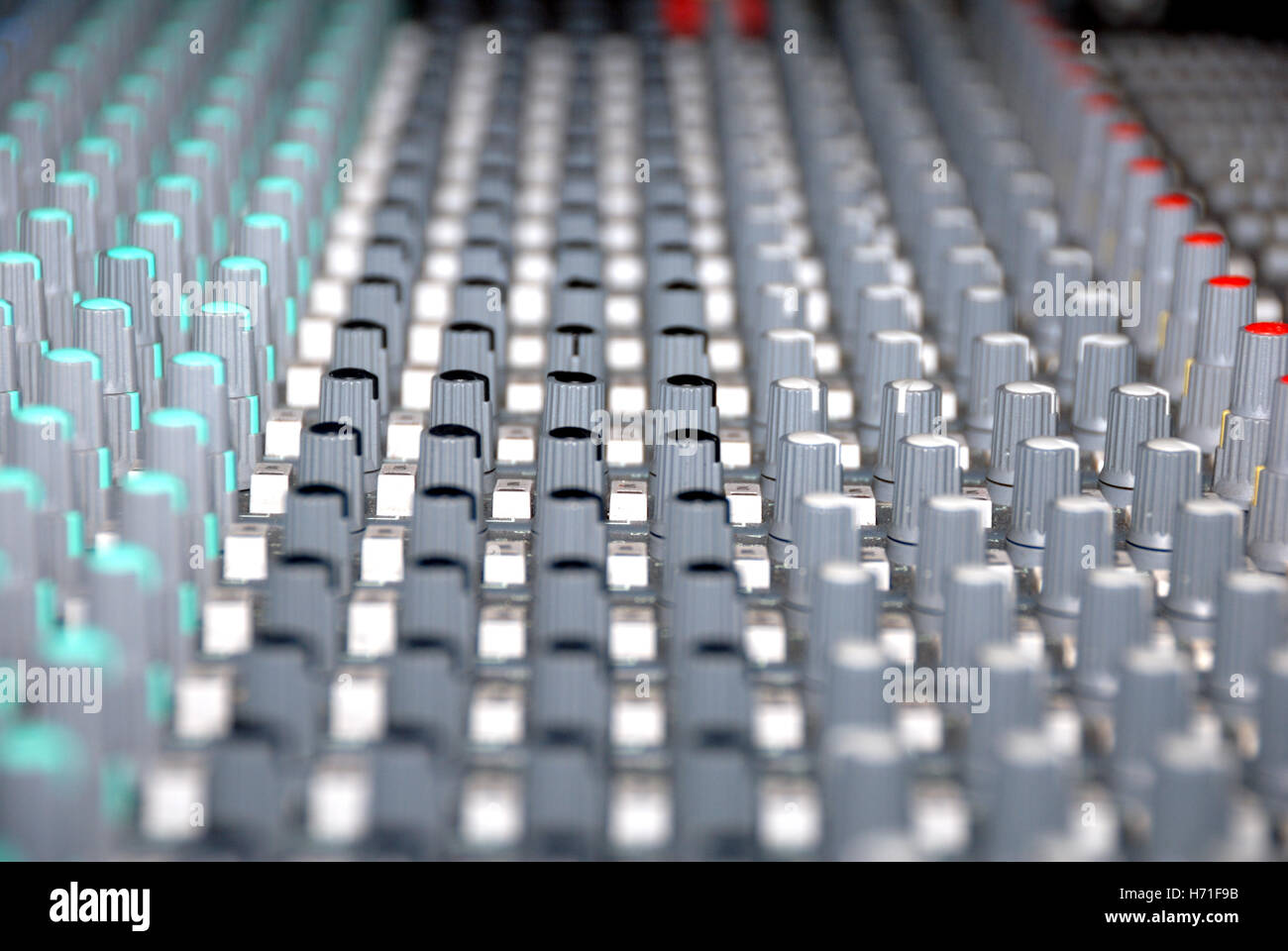 Audio mixing console in a recording studio. Faders and knobs of a sound