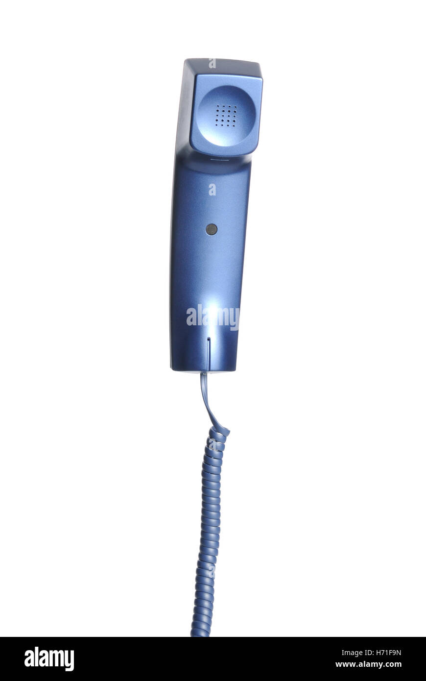 A business telephone receiver hangs by its telephone cord against a white background Stock Photo