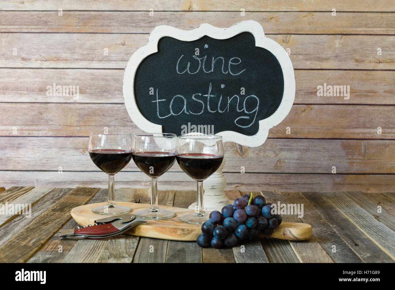 Red wine flight with chalkboard sign and grapes Stock Photo